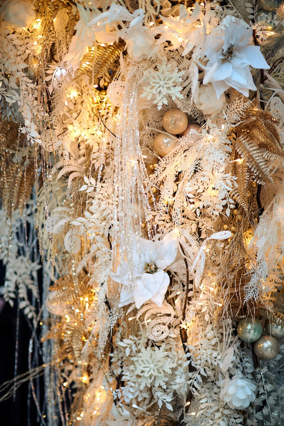 a christmas tree with white and gold decorations