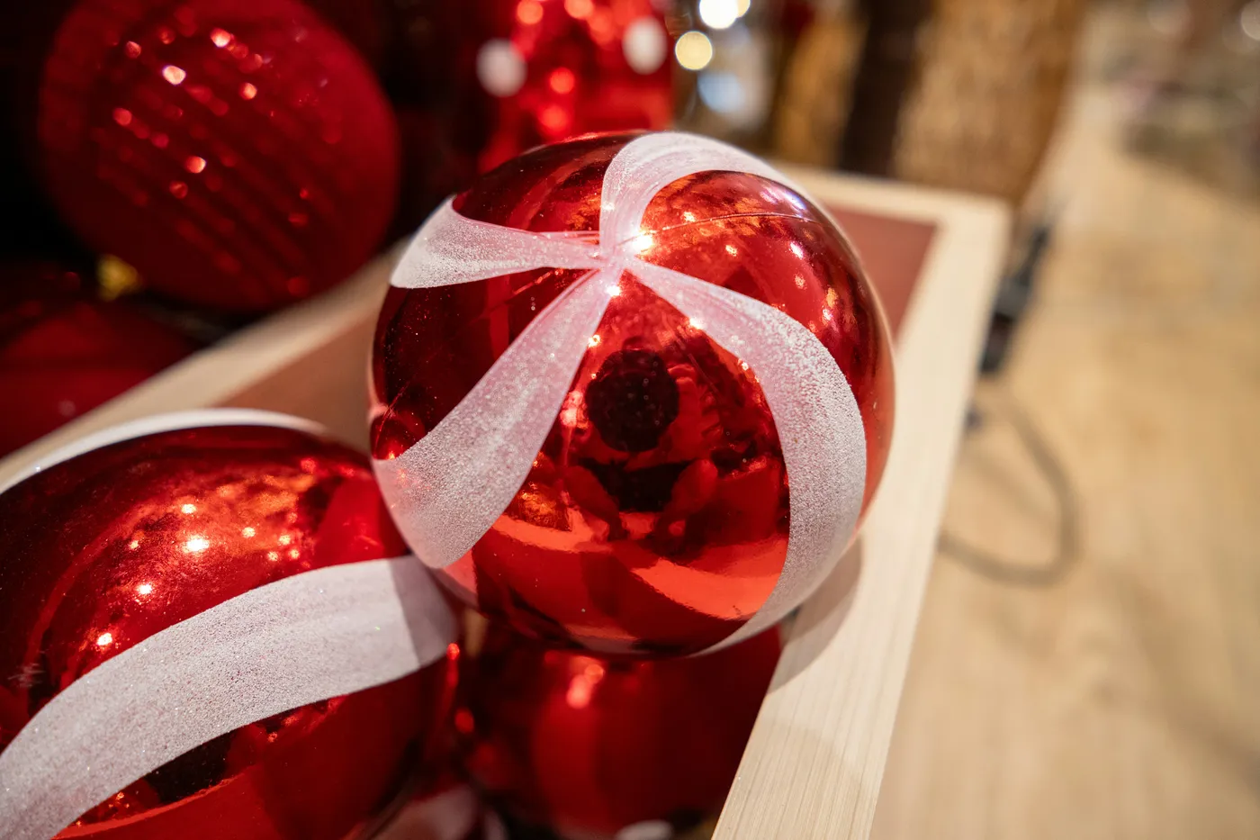 a close up of a red ornament with a white ribbon