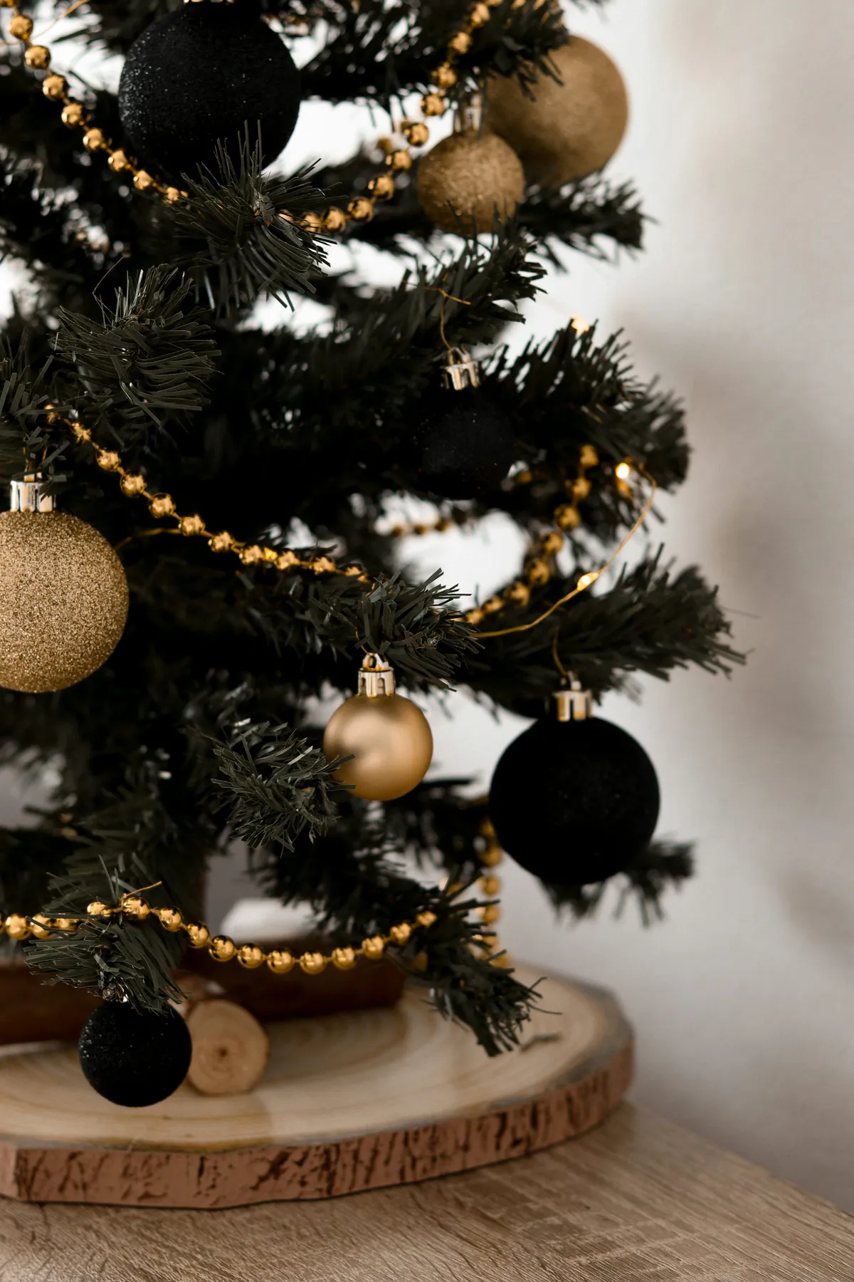 A small christmas tree with black and gold ornaments - Free Photo on  Unsplash