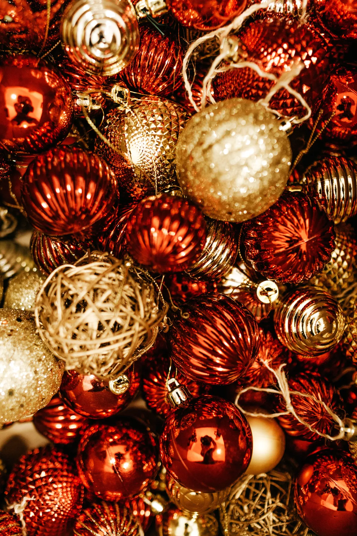 A vibrant collection of red and gold Christmas ornaments for holiday decoration.