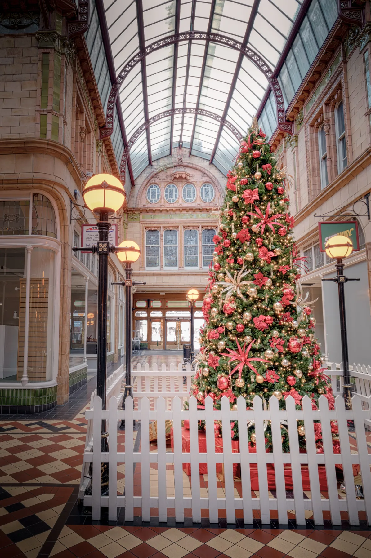 Charming Victorian shopping arcade with a festive Christmas tree, located in England.