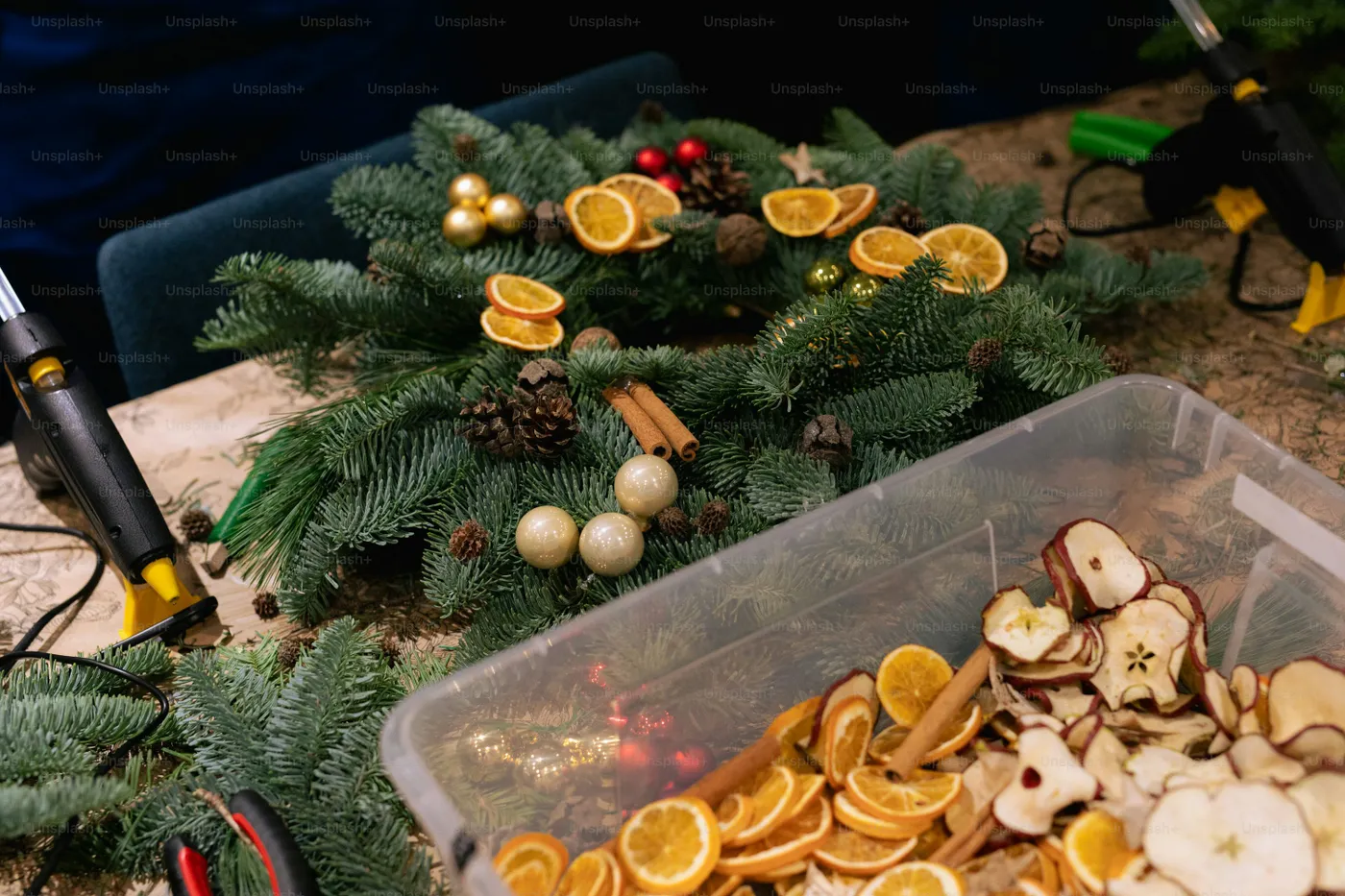 Christmas wreath decoration with dried oranges and pinecones - Photo on Unsplash+