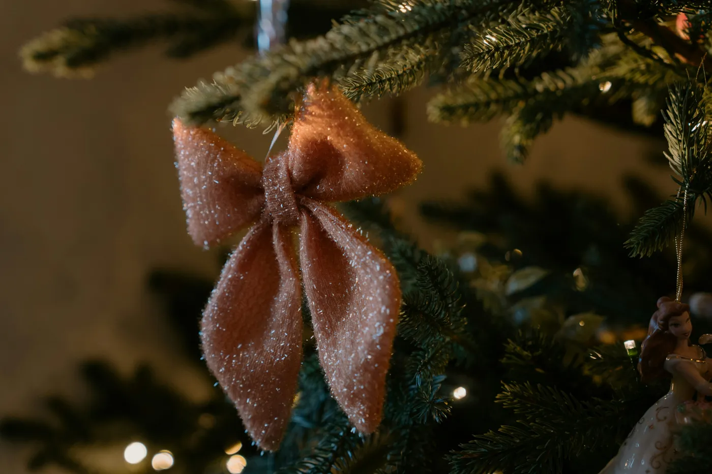 Close-up of a glittery pink bow on a christmas tree