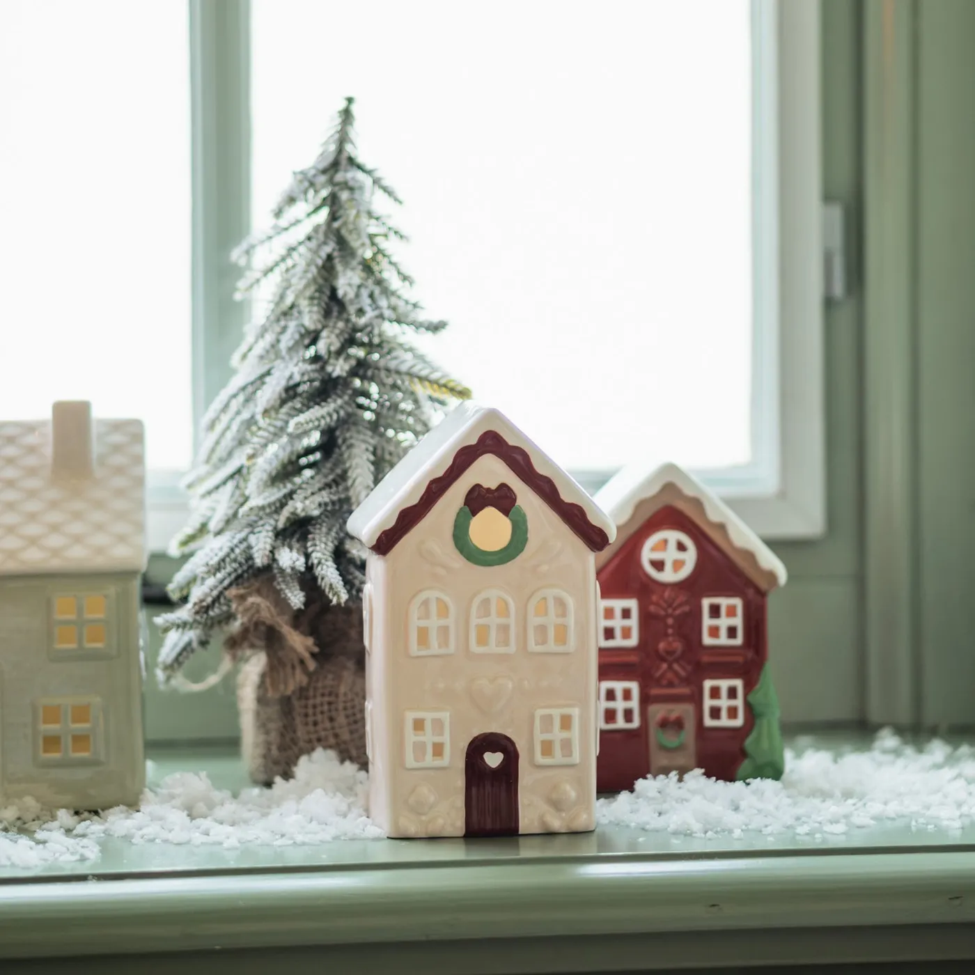 Colourful Christmas houses with LED and snowy trees