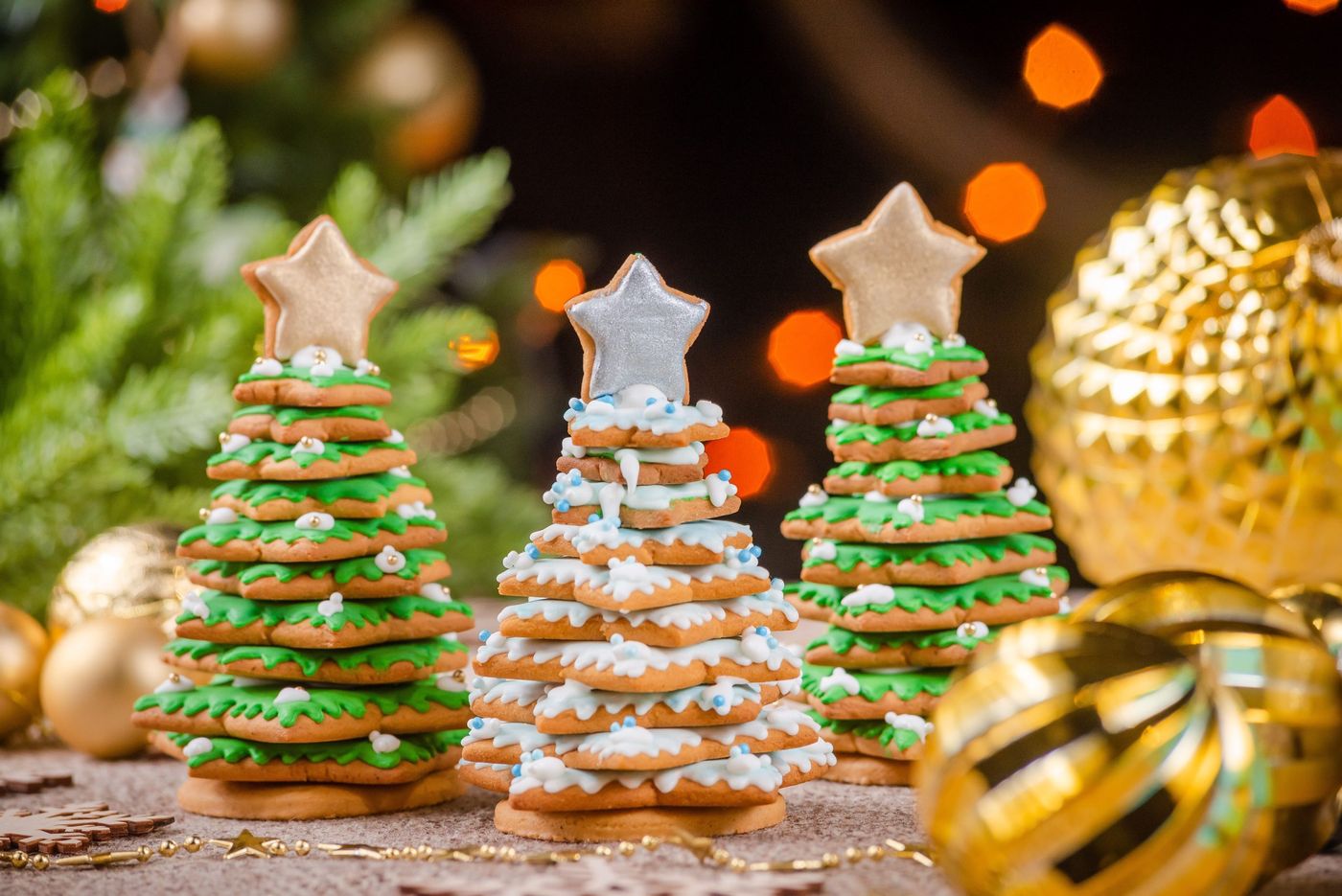 Delightful Christmas tree cookies with star toppers and bokeh background.