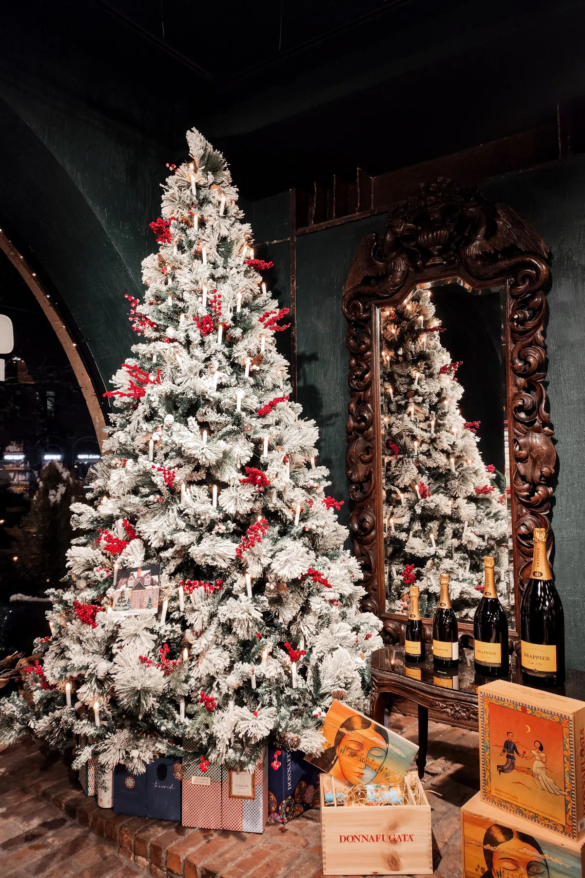 Elegant Christmas scene with a decorated tree, gifts, and champagne in a cozy interior in Yerevan, Armenia.