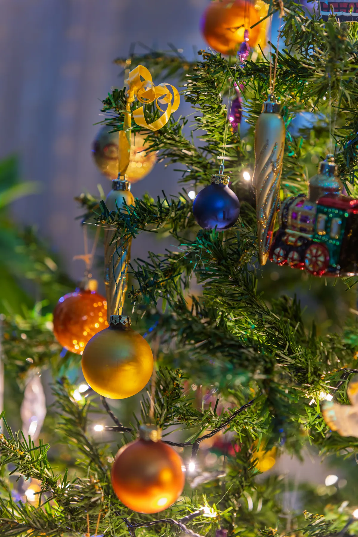 Festive Christmas tree adorned with colorful ornaments and twinkling lights, capturing holiday spirit.