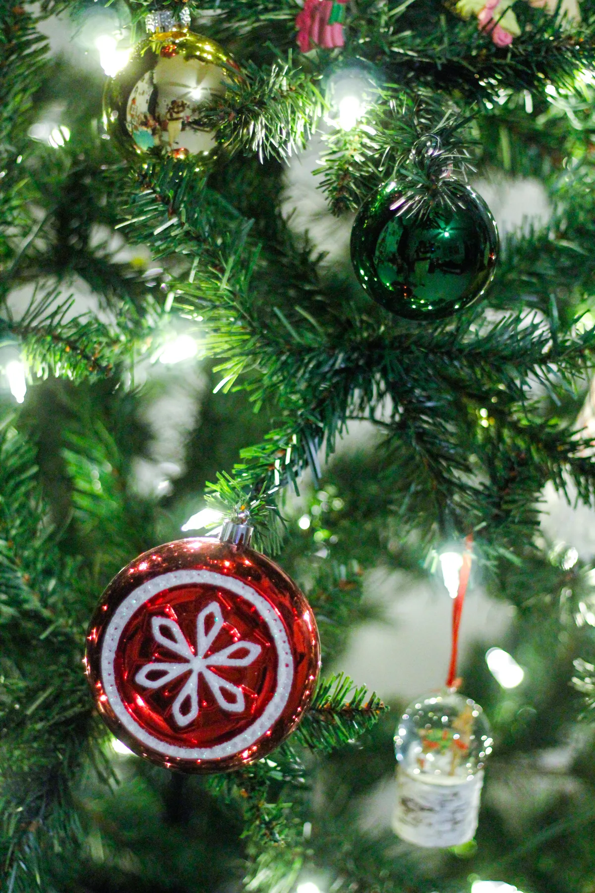 Festive Christmas tree with colorful ornaments and warm lights.