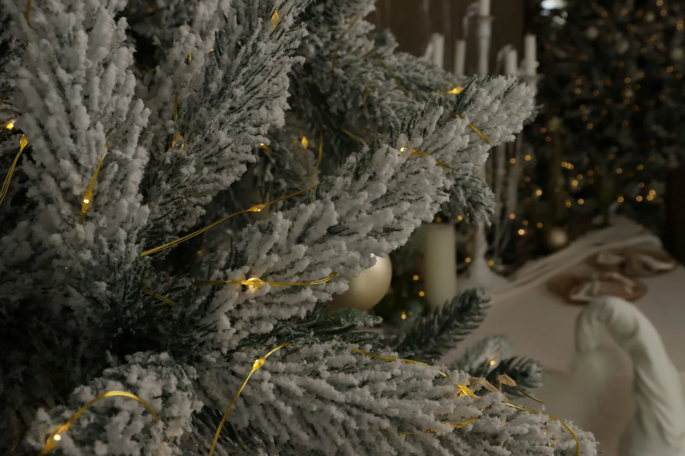 Flocked christmas tree with warm fairy lights
