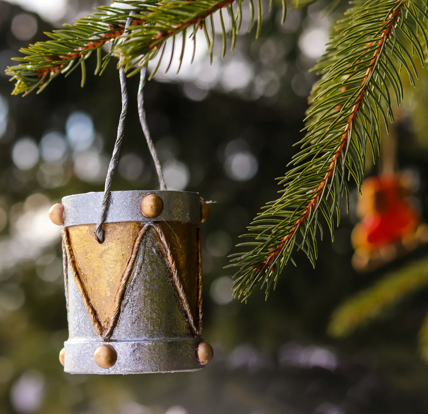 gold bell hanging on green pine tree