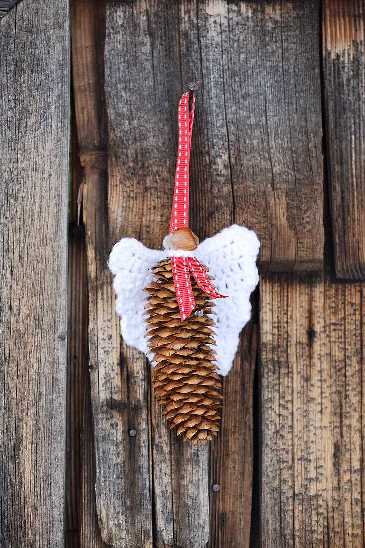 Handmade pine-cone angel – Buy image – 12464346 ❘ GardenImage