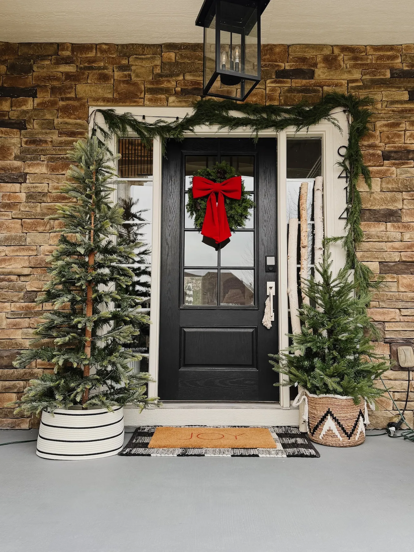 How to Create a Cozy Holiday Porch with Faux Trees and Garland - Life Love  Larson