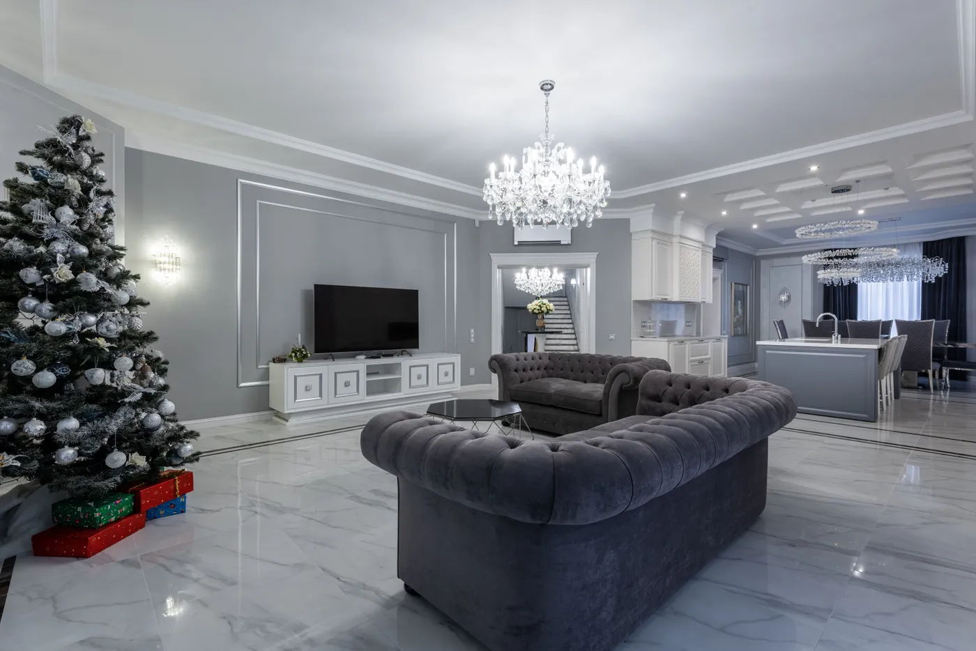 Interior of empty contemporary living room with stylish furniture and festive Christmas tree in daytime