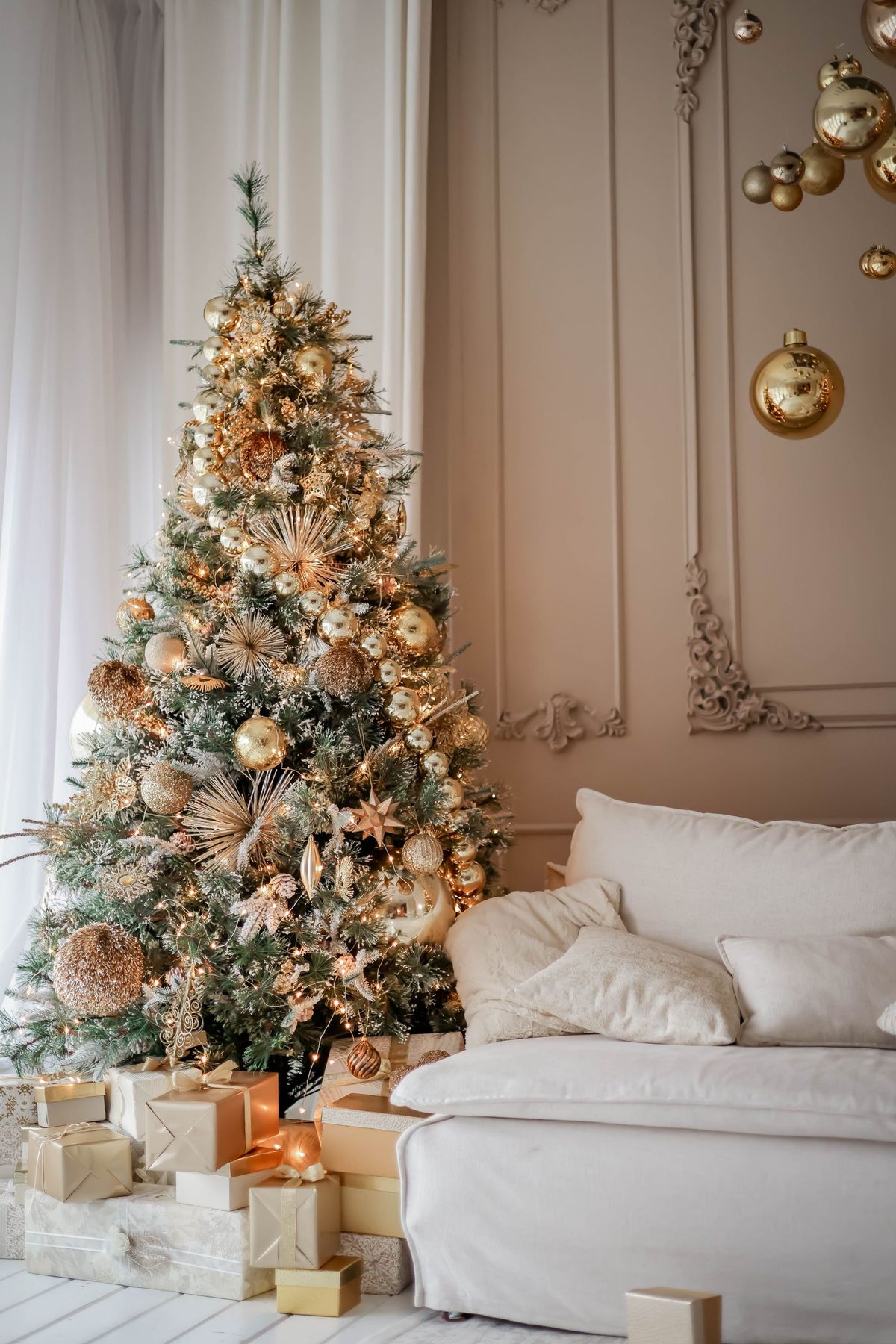 Luxurious living room featuring a lavishly decorated Christmas tree and gifts, perfect for holiday inspiration.