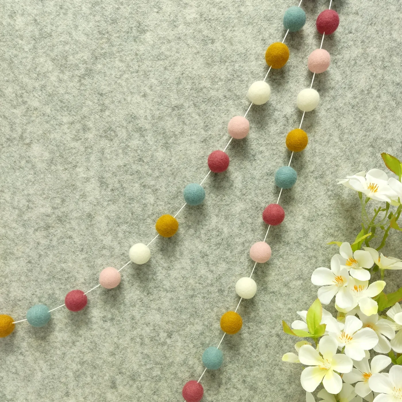 Scandinavian pink & blue felt ball garland baby room | CELAINEDECO